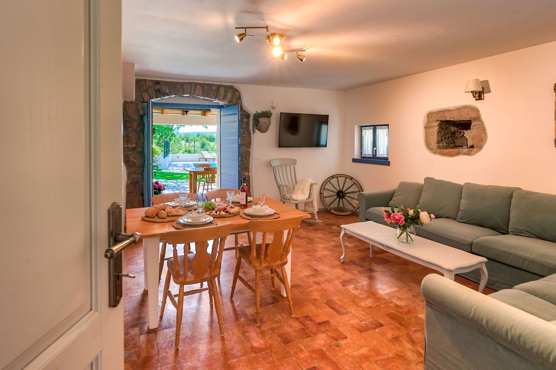 Living and dining room with stone archway